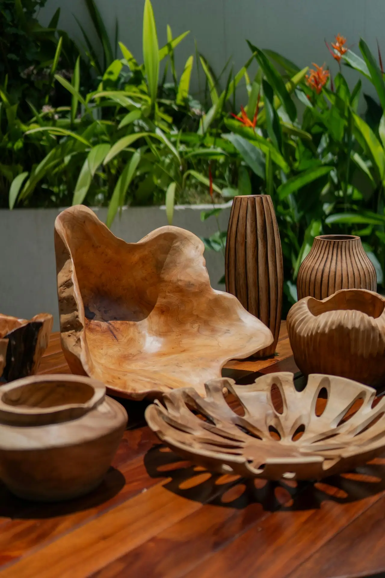 Beautiful rustic wooden decor displayed on a wooden table surrounded by greenery, perfect for natural home styling.
