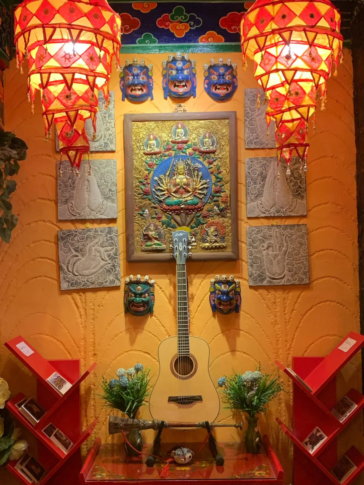 Colorful indoor decor with Asian motifs, a guitar, and vibrant lanterns creating a cultural ambiance.